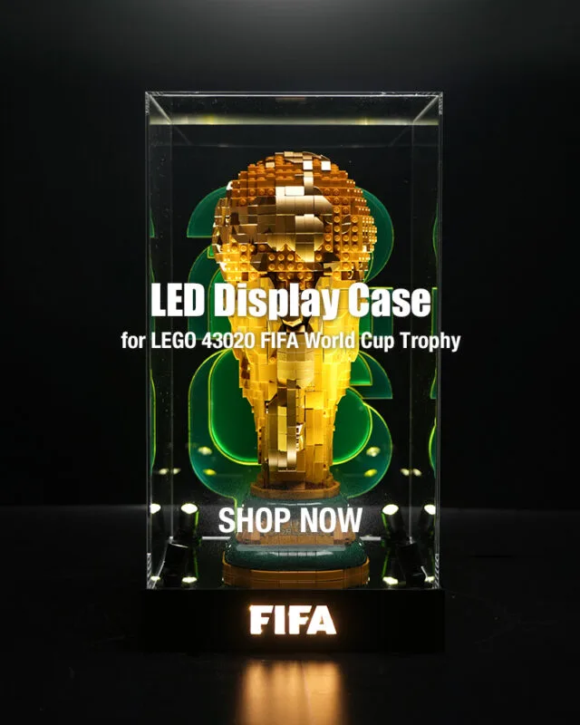 LED display case housing a gold LEGO World Cup Trophy, with 'SHOP NOW' text and FIFA branding at the base