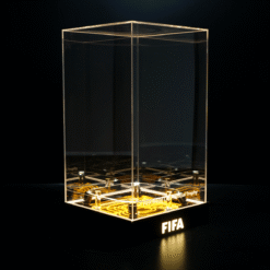 Clear glass display case on a lit black base with the FIFA logo, empty inside.