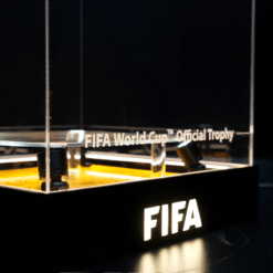 FIFA World Cup Official Trophy on display inside a glass case with a black base and illuminated pedestal area