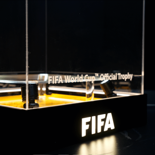 FIFA World Cup Official Trophy on display inside a glass case with a black base and illuminated pedestal area