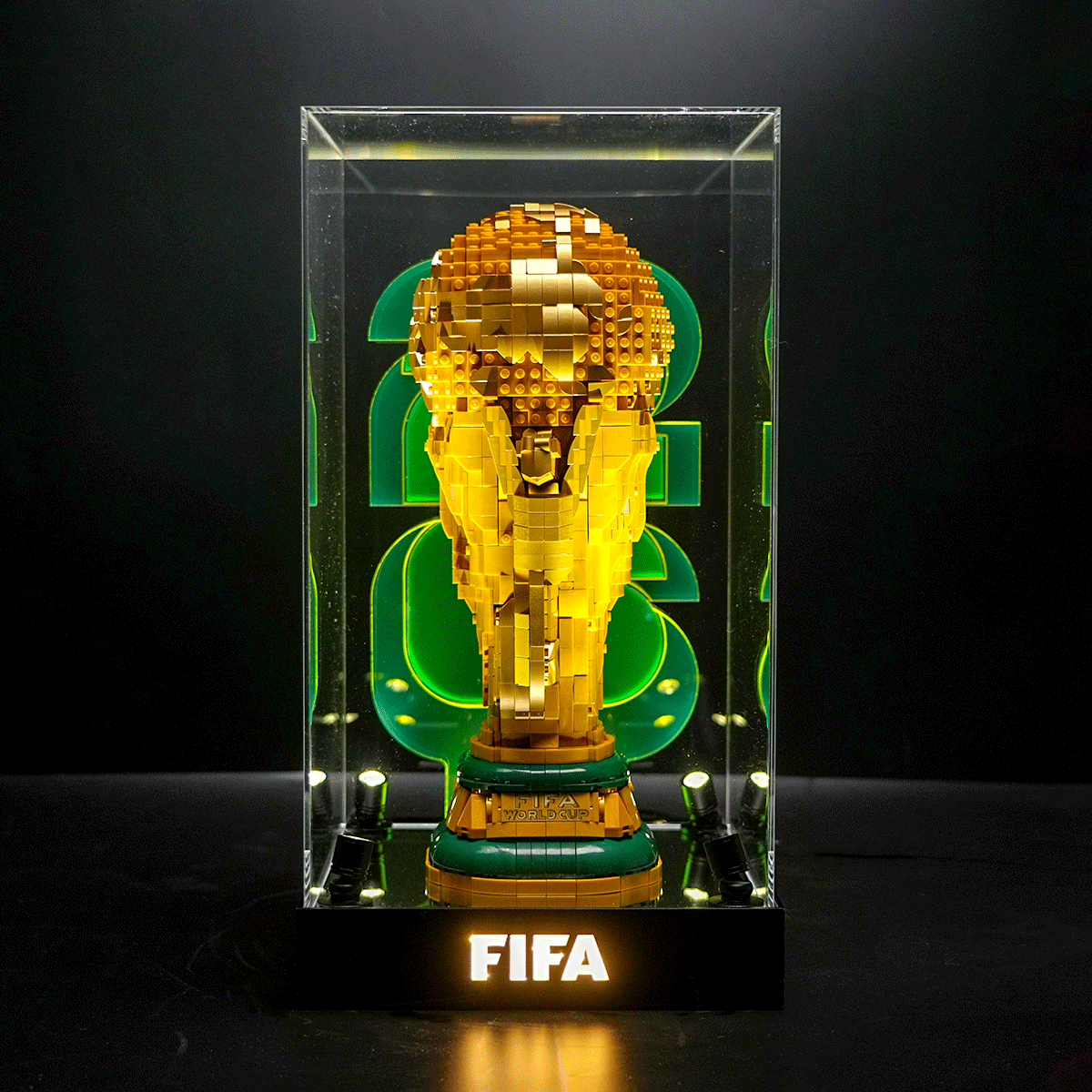 LEGO brick sculpture of the FIFA World Cup trophy inside a glass display case with an illuminated base reading FIFA