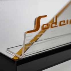 Close-up of a glass display with orange, stylized lettering and engineering terms like Powertrain and Displacement.