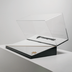 Open clear display case atop a black base with gold trim and a small gold emblem, ready to showcase items