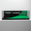 A glass display panel featuring Aston Martin, Aramco, and F1 branding in black and green with a diagonal design motif.