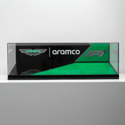 A glass display panel featuring Aston Martin, Aramco, and F1 branding in black and green with a diagonal design motif.