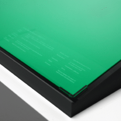 Close-up of a green translucent panel set in a black frame at an angle.
