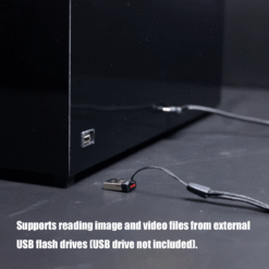 Black device with a USB flash drive plugged in; caption indicates it can read image and video files from external USB drives (drive not included).