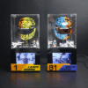 Two clear display cases show colorful racing helmets (yellow/black and blue/orange) with mini figurines and podium plaques reading 'Lando Norris' and 'Oscar Piastri' respectively, on a black base with screens beneath.