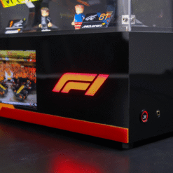 Black display cabinet with a bold red F1 logo on the front and miniature figurines inside, plus branded cards visible on top shelf.